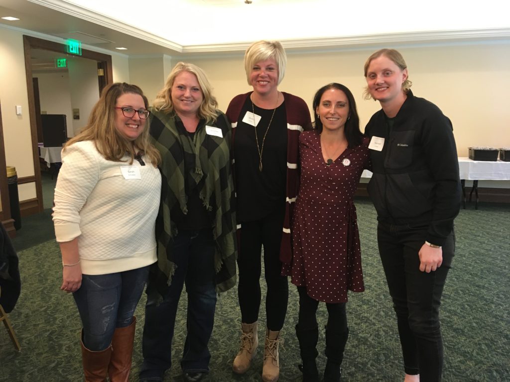 Five woman standing together smiling