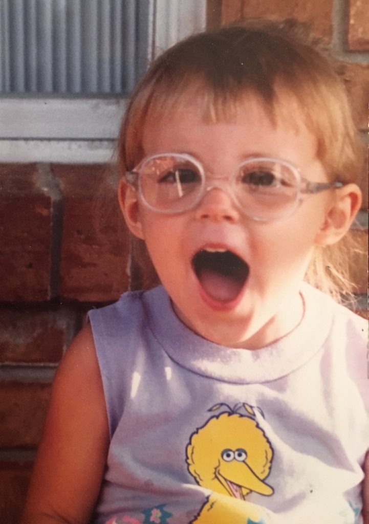 little kid with big glasses and big smile