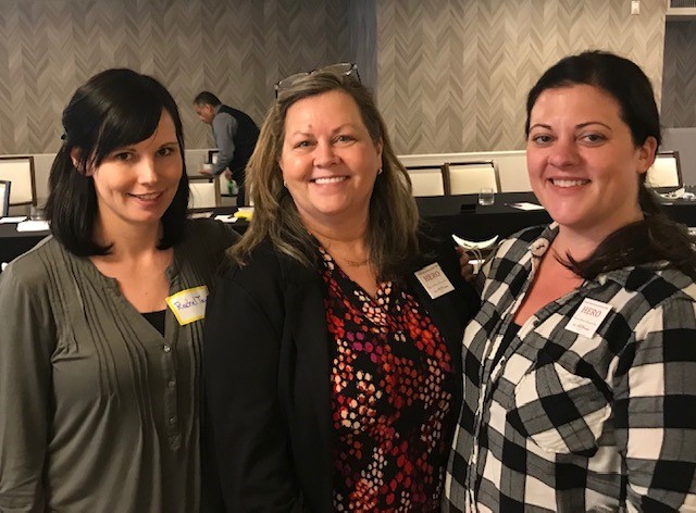 three women smiling at camera