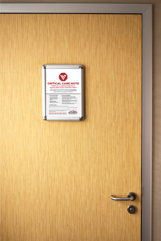 A mockup of the Hospital Sign for VEDS Inpatients prominently displayed on the door of an inpatient hospital room.