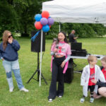 Maia speaks into a microphone at the Chicago Walk for Victory, raising awareness for Vascular Ehlers-Danlos syndrome.
